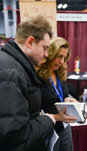 Linda Fischer speaking with an attendee at the NY Travel Show